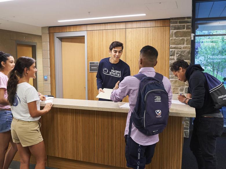 Students at front desk of Penn State Abington lions gate near Philadelphia