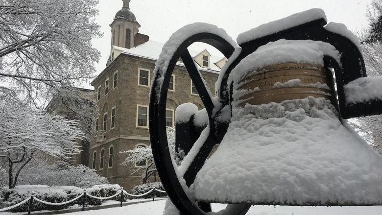 Snow falls on Old Main bell